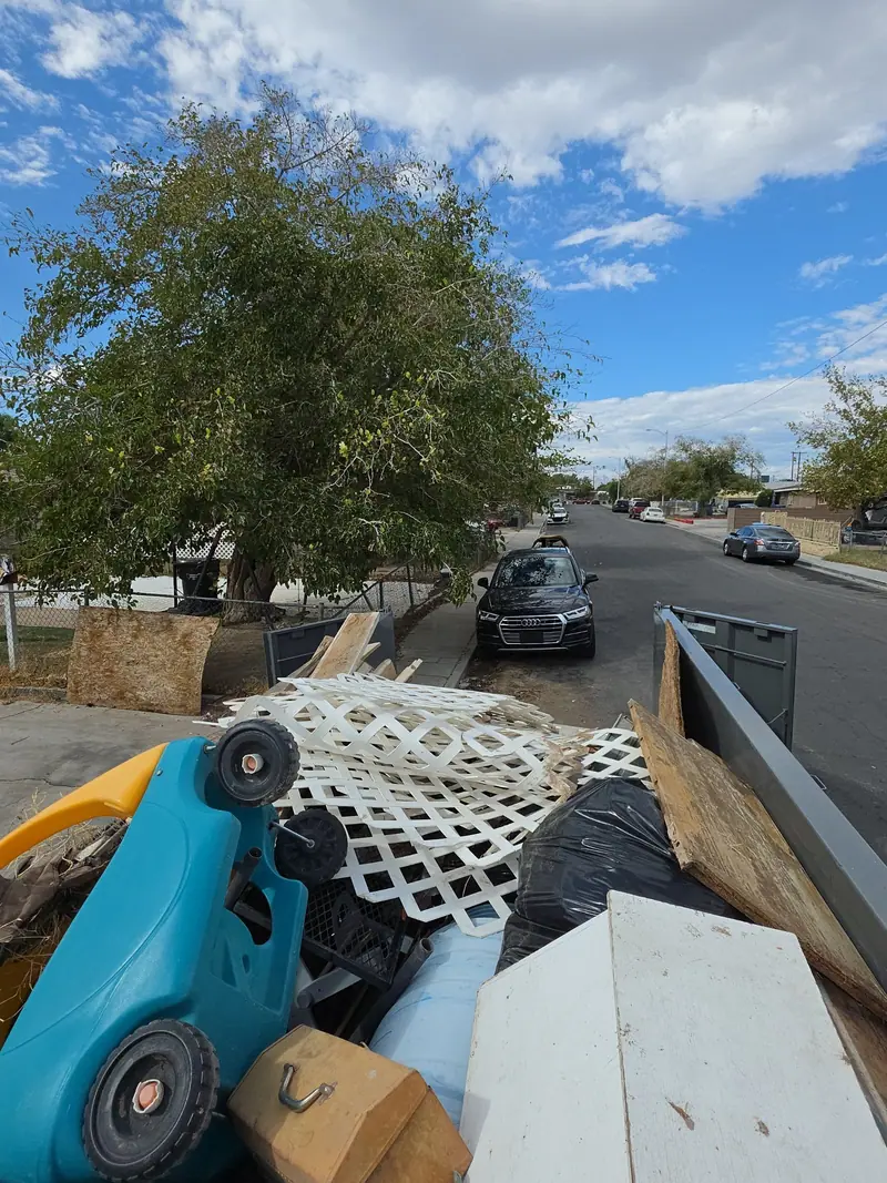 A white cabinet, lattice and household items in the Legend Hauling trailer
