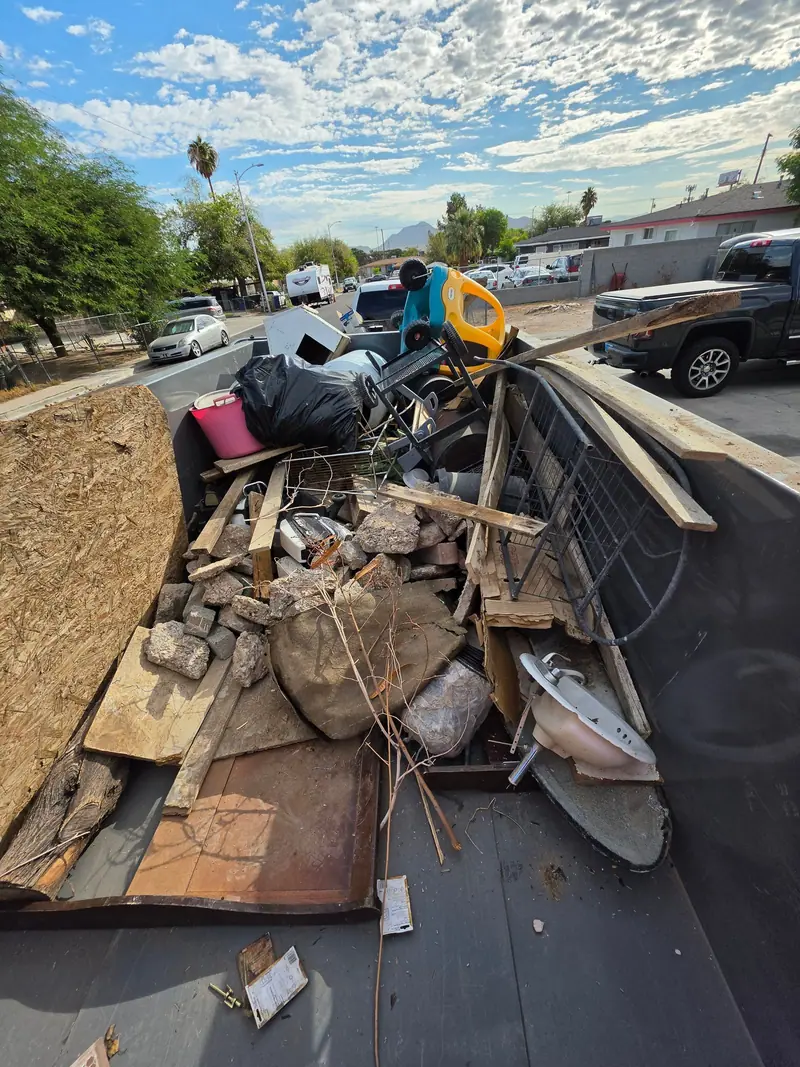 Lumber, bricks and remodel scrap piled in the trailer