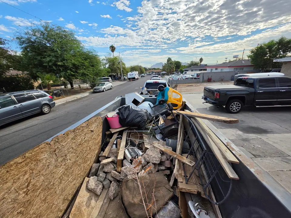 Dump trailer loaded with broken lumber, bricks and remodel debris on a Las Vegas street