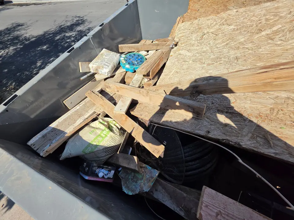 Plywood sheets and lumber scrap in the dump trailer