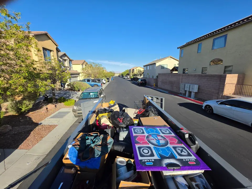 Legend Hauling dump trailer loaded with household junk on a Las Vegas valley street