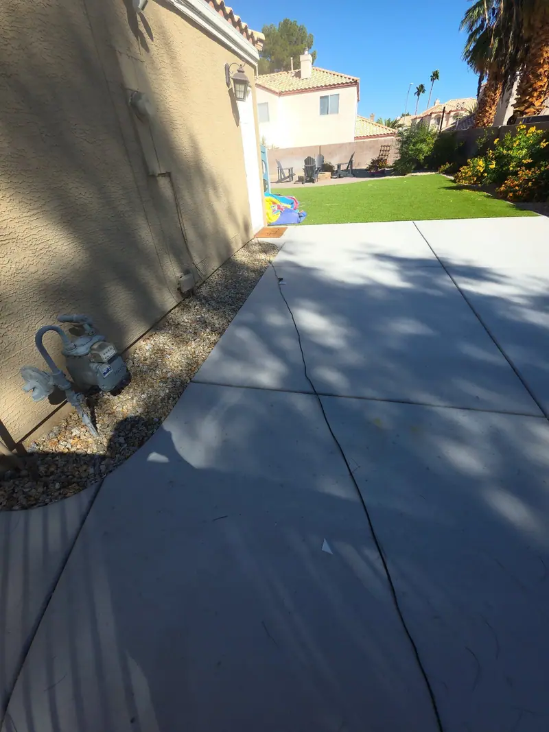A cleared side walkway beside a stucco home after a cleanout