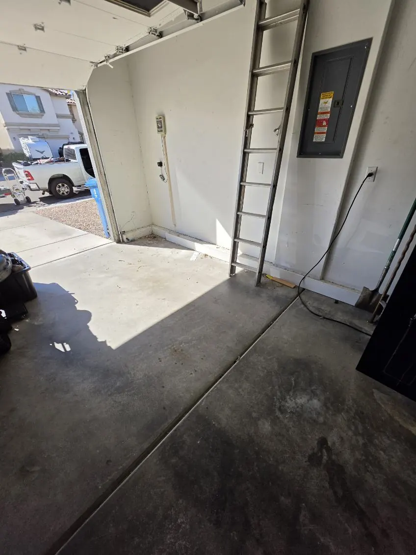 The same garage after the cleanout, floor clear from the door to the ladder