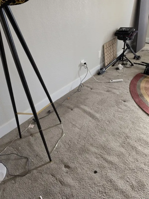Music room corner after the gear was cleared, carpet showing