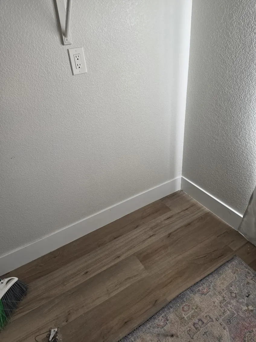 Empty laundry nook corner with a clean floor after the cleanout