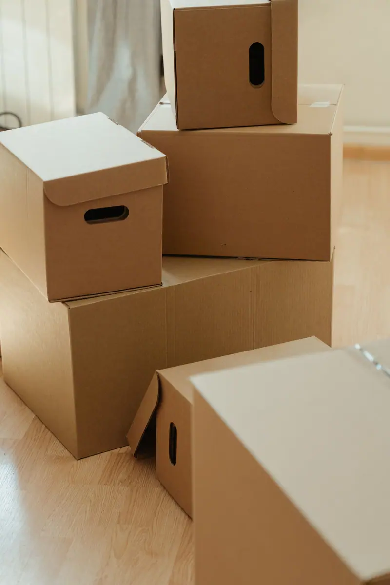 Packed cardboard boxes stacked in an empty room (representative photo)