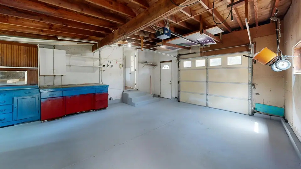 An emptied two-car garage with a bare floor (representative photo)